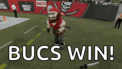 Bucs Mascot Standing On Field Saying Bucs Win GIF