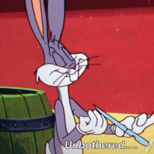 Bugs Bunny From Looney Tunes Is Holding A Knife And Says " Unbothered " GIF