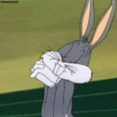 Bugs Bunny From Looney Tunes Is Holding His Fist Up In Front Of His Face GIF