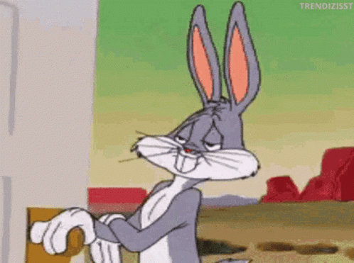 Bugs Bunny From Looney Tunes Is Standing In Front Of A Door And Looking At The Camera . GIF