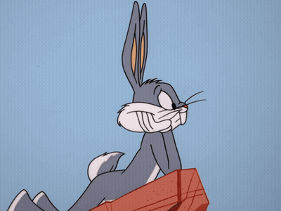 Bugs Bunny From The Looney Tunes Show Is Sitting On A Red Box GIF