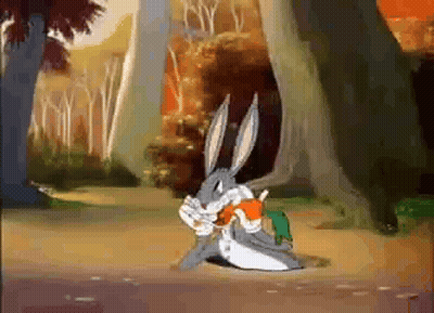 Bugs Bunny Is Eating A Carrot In A Cartoon Scene GIF