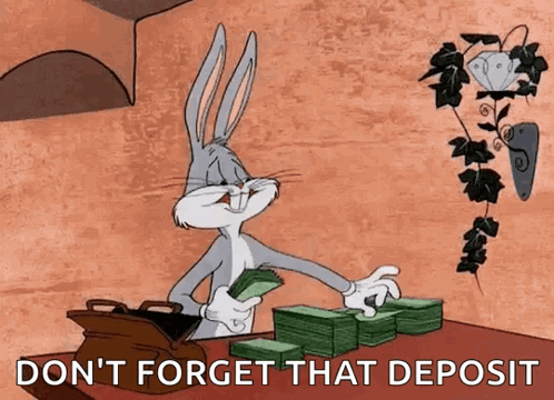 Bugs Bunny Is Sitting At A Table With A Stack Of Money And A Bag Of Money . GIF