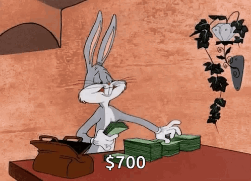 Bugs Bunny Is Sitting At A Table With A Stack Of Money . GIF