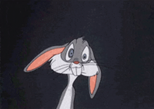 Bugs Bunny Is Sitting Down With His Hands Folded In Front Of Him GIF