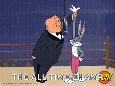 Bugs Bunny Is Standing Next To A Man In A Tuxedo In A Boxing Ring Holding A Trophy . GIF