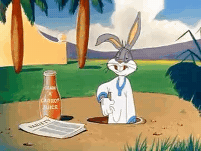 Bugs Bunny Is Sticking His Head Out Of A Hole In The Ground Next To A Bottle Of Carrot Juice . GIF