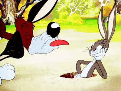 Bugs Bunny Laying On Ground With Tongue Out GIF