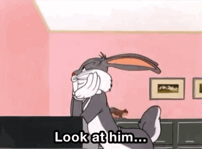 Bugs Bunny On Pink Wall With Look At Him Sign GIF