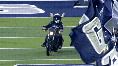 Bull Mascot Riding Motorcycle On Field GIF
