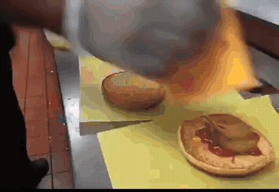 Bunch Of Hamburgers On Yellow Cutting Board GIF