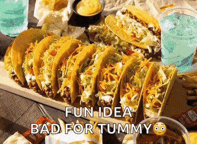 Bunch Of Tacos On Wooden Cutting Board GIF