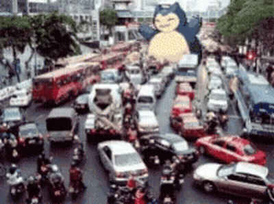 Busy City Street With Snorlax Statue GIF