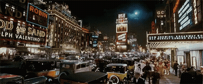 Busy Night Street With Robin Sign GIF