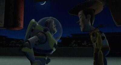 Buzz Lightyear And Woody Are Standing Next To Each Other At Night GIF