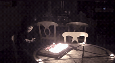 Cake With Candles On Table In Dark GIF