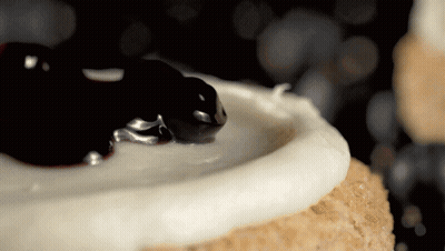 Cake With White Frosting And Blueberry Sauce GIF