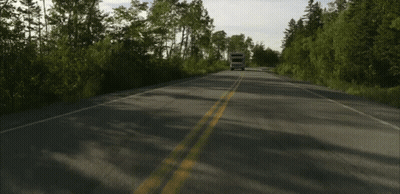 Camper Driving On Road With Trees GIF