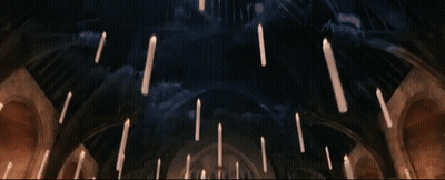 Candles Hanging From The Ceiling In A Dark Room GIF