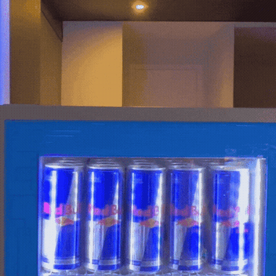 Cans Of Red Bull Are Lined Up In A Fridge GIF
