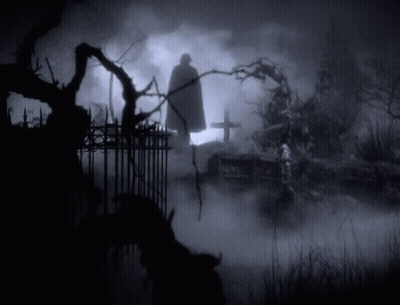 Caped Man Silhouette In Cemetery At Night GIF