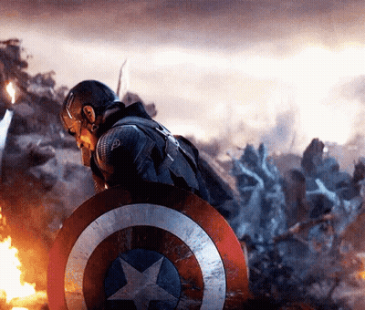 Captain America Is Holding A Shield In Front Of A Group Of Soldiers . GIF