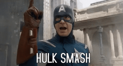 Captain America Is Pointing Up And Saying `` Hulk Smash '' While Wearing A Mask And Gloves . GIF