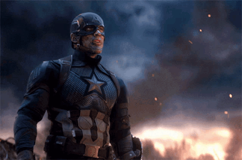 Captain America Is Standing In Front Of A Fire And Smoke GIF