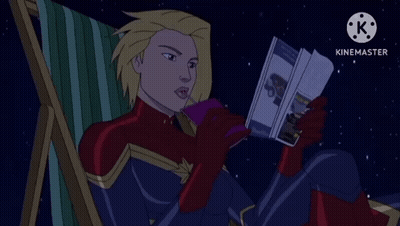 Captain Marvel Sitting In Chair Reading Book GIF