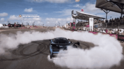 Car Drifting On Track With Hall Of Fame Sign GIF