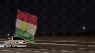Car Driving At Night With Flag GIF