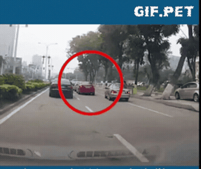 Car Driving Down City Street GIF