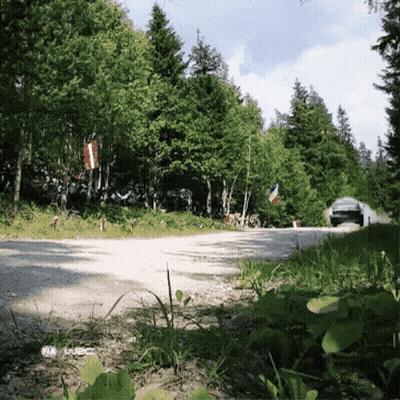 Car Driving Down Dirt Road In Woods With Iveco GIF
