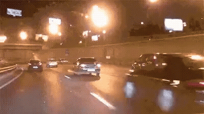 Car Driving Down Highway At Night With Lights GIF