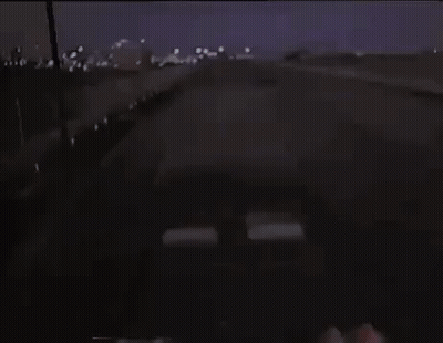 Car Driving Down Highway Past Anywhere Sign GIF
