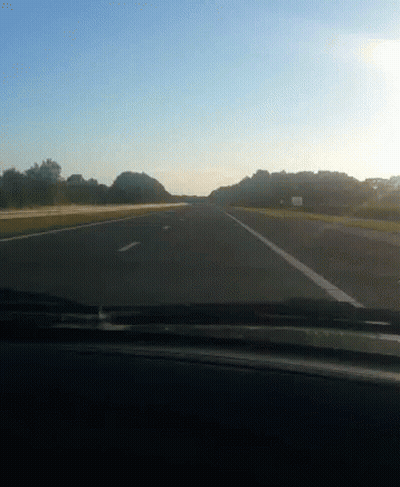 Car Driving Down Highway With Trees GIF
