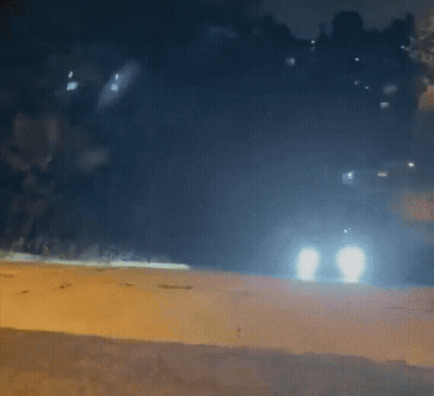 Car Driving Down Road At Night GIF