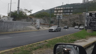 Car Driving Down Road Next To Sign Saying #Wepro GIF