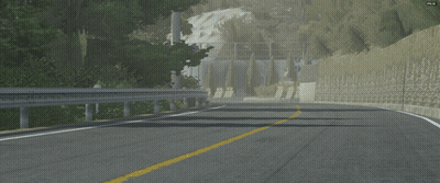 Car Driving Down Road Next To Stone Wall With Aomori Sign GIF