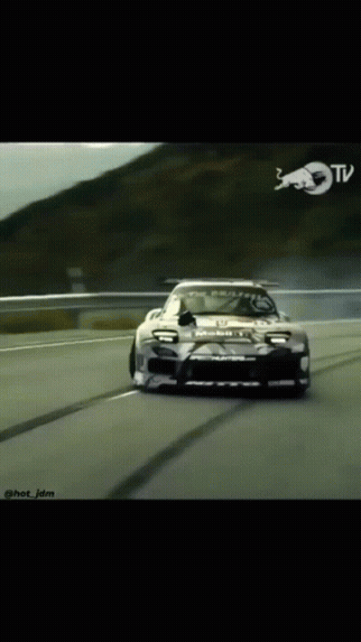 Car Driving Down Road With Red Bull Logo GIF