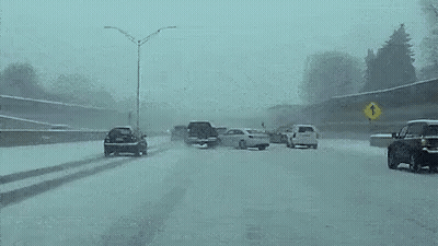 Car Driving Down Snowy Highway East Bound GIF
