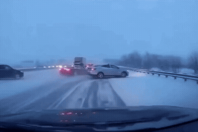 Car Driving Down Snowy Highway GIF
