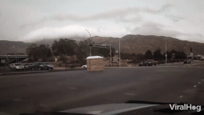 Car Driving Down Street With Mountains Viralhog GIF