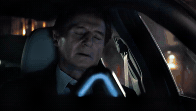 Car Driving Down Wet Street At Night With No Parking Sign GIF