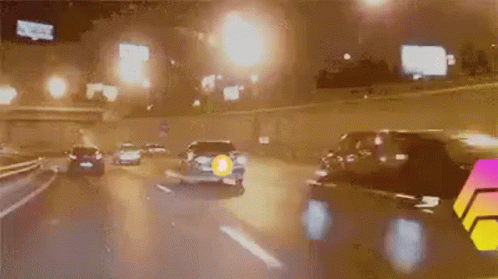 Car Driving On Highway At Night With Yellow Circle GIF