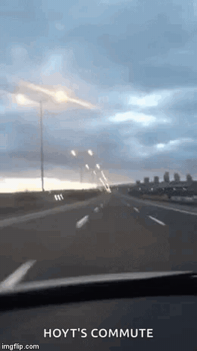 Car Driving On Highway Under Cloudy Sky GIF