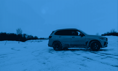 Car Driving Through Snowy Field With Trees GIF