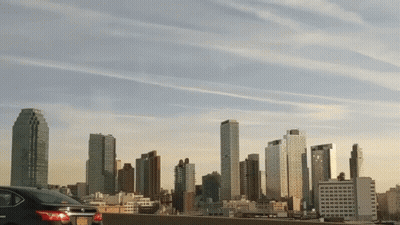 Car Parked In Front Of City Skyline GIF