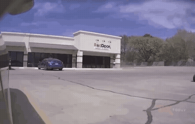 Car Parked In Front Of Reddoor Building GIF