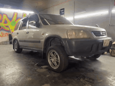 Car Parked In Garage With Graffiti A GIF